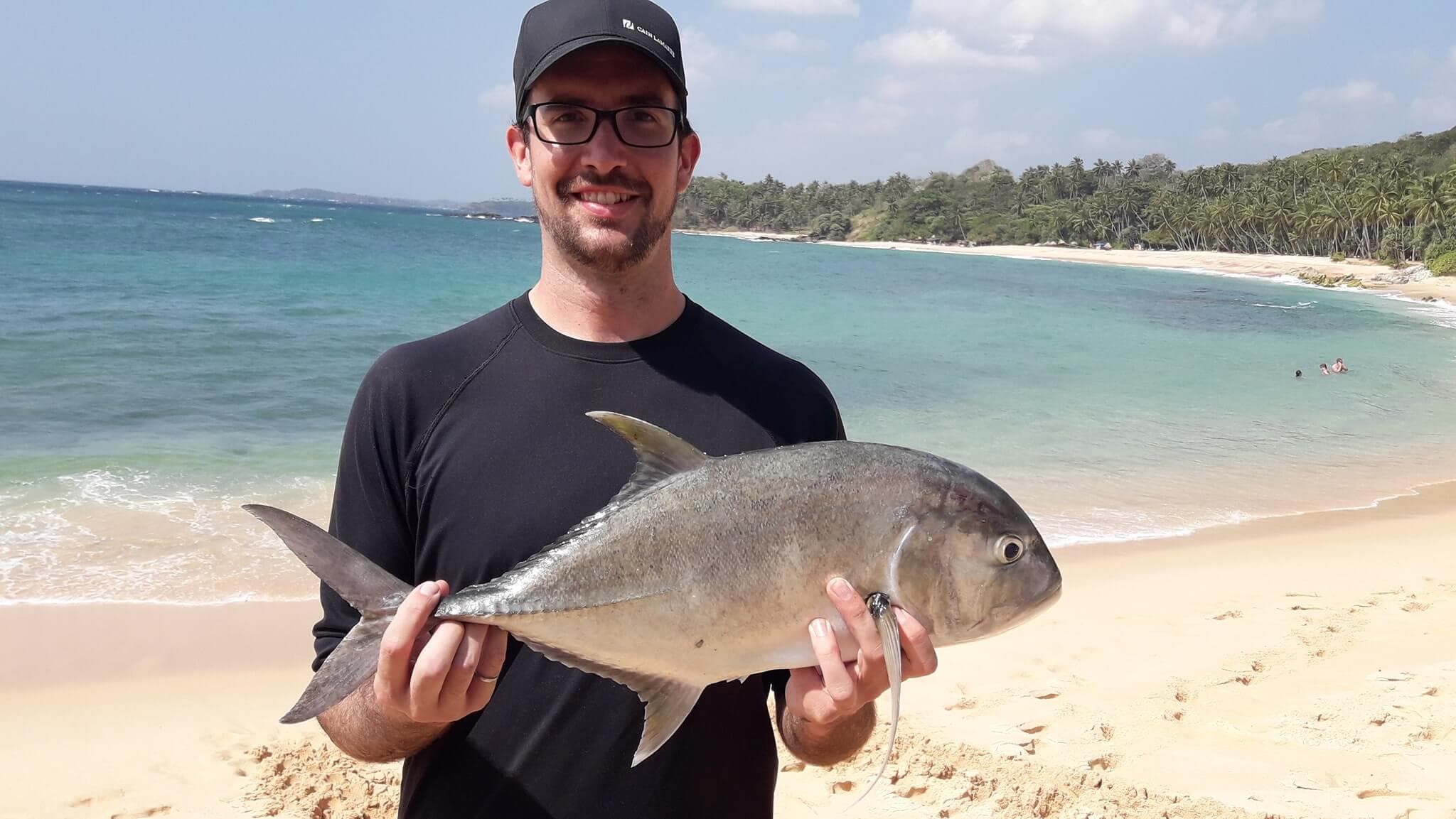 Турист поймал рыбу Тревалли во время рыболовного тура на Шри-Ланке.