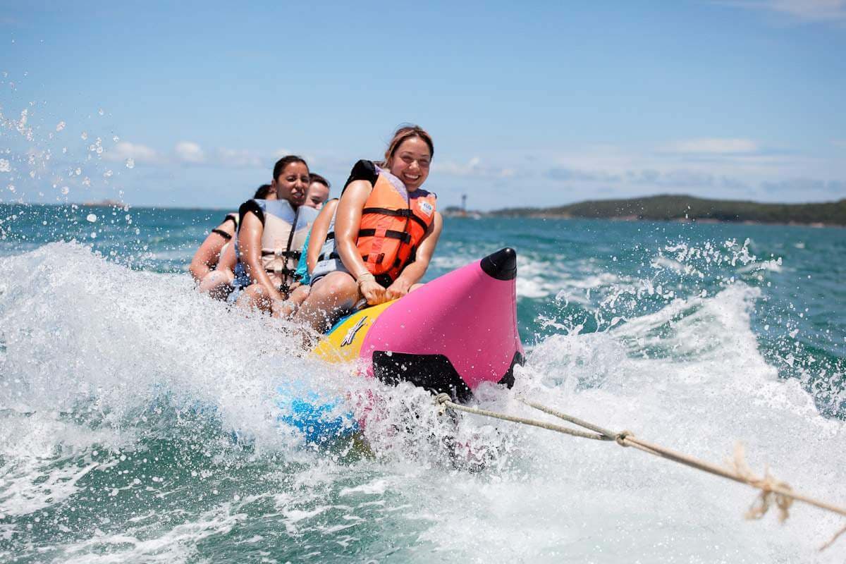 A family ride banana boat splashing water in Bentota