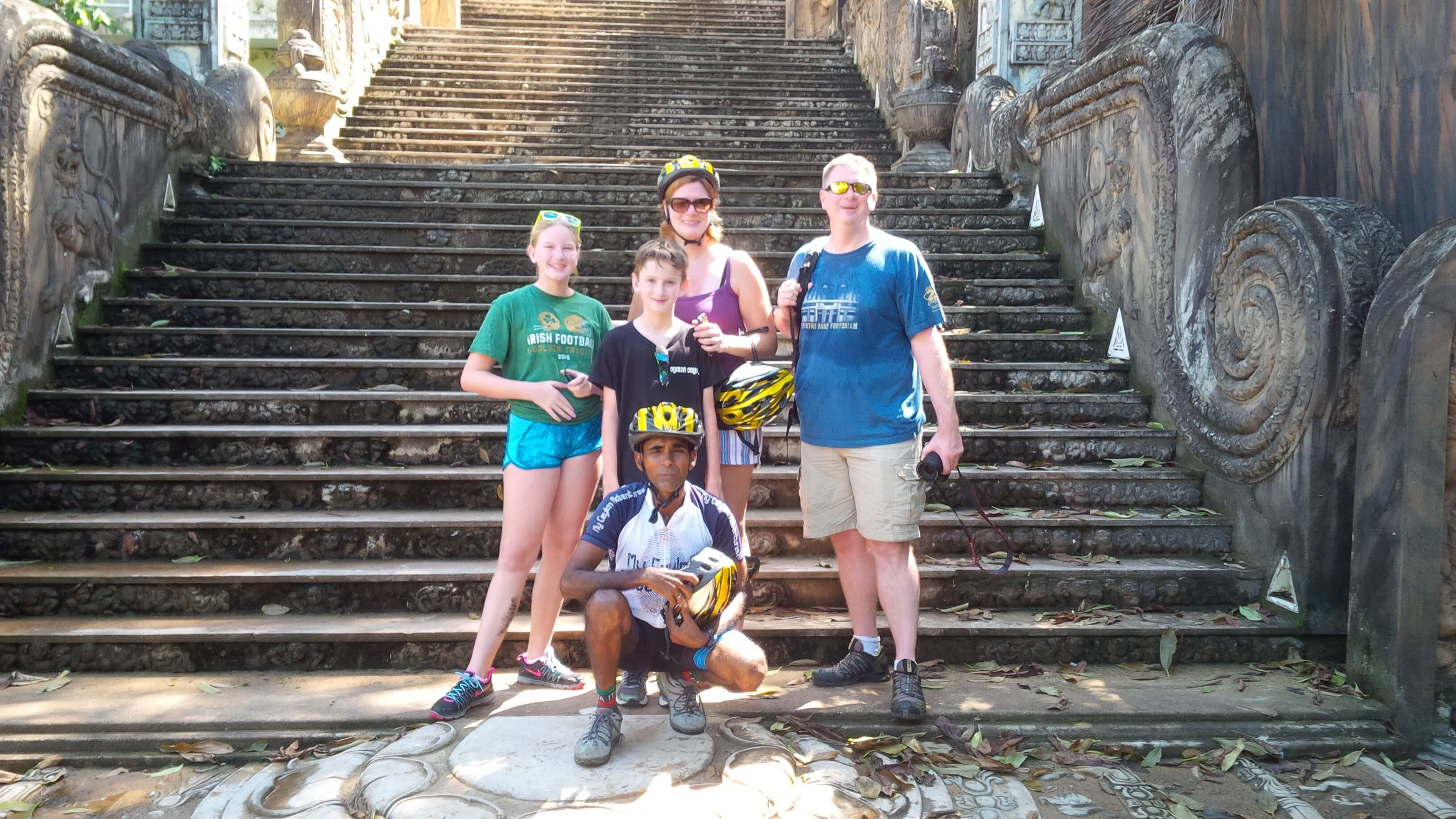 A photo of cyclists on the ancient temple steps and moonstone 