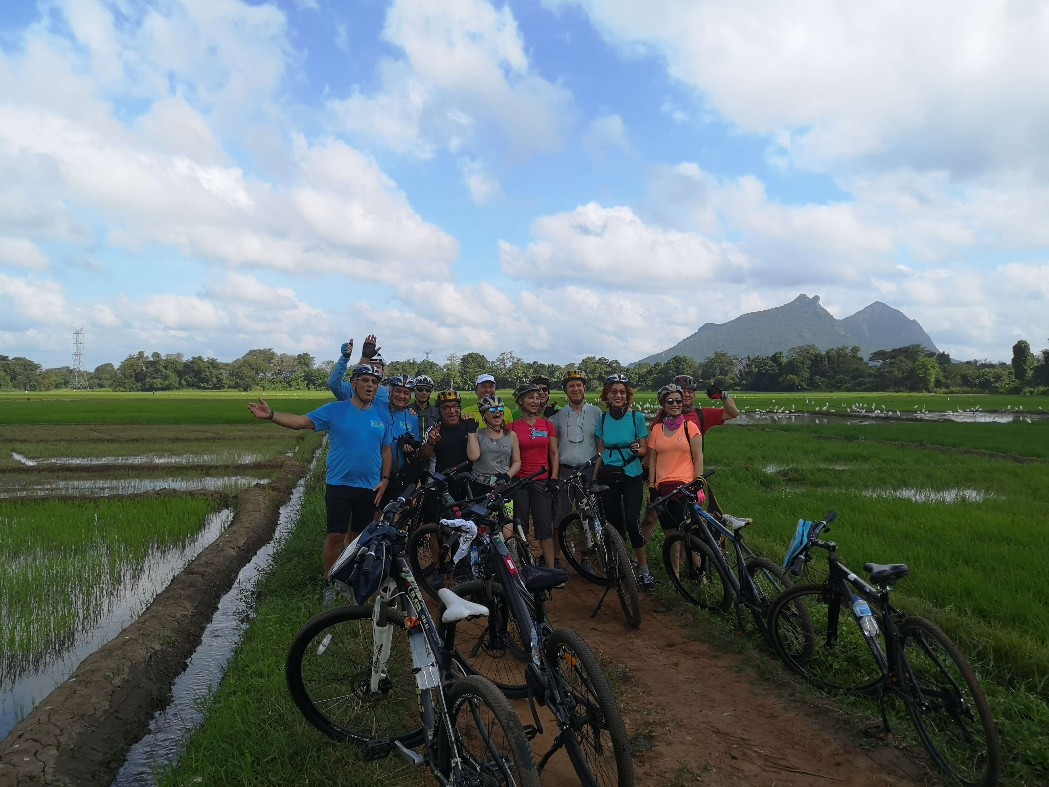 Group of tourists taking a photo in a beautiful paddy field in Sri Lanka