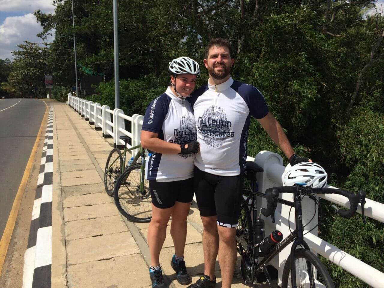A couple take a break on the bridge during the cycling tour