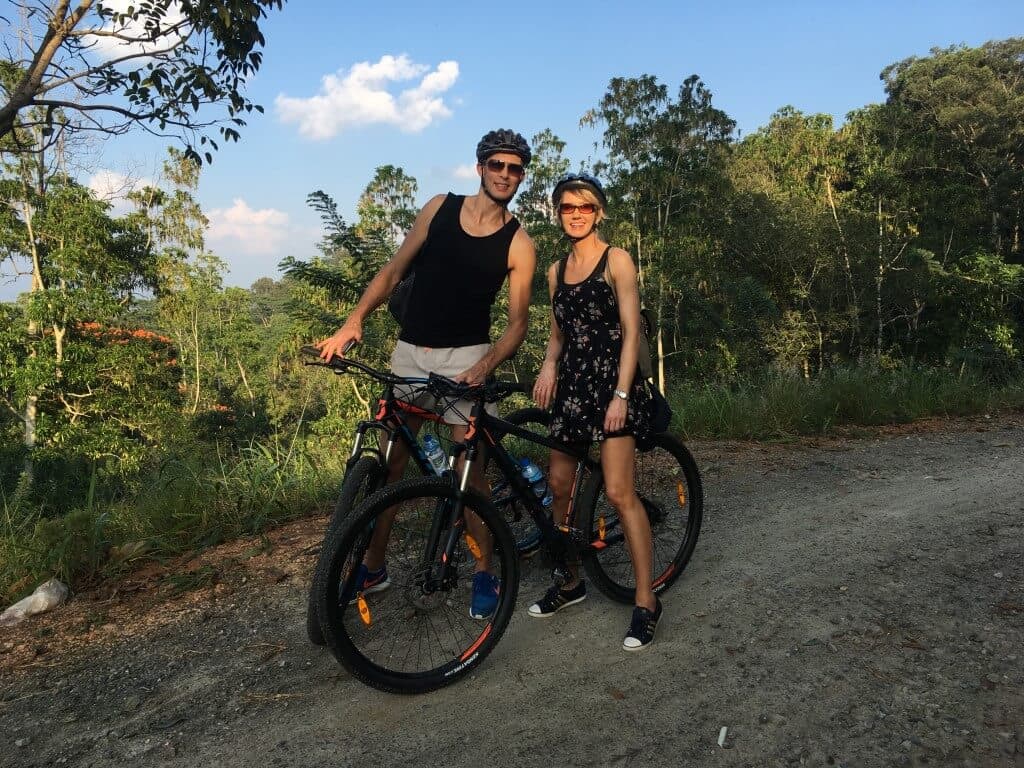 The tourist couple cycling in beautiful Kithulgala countryside