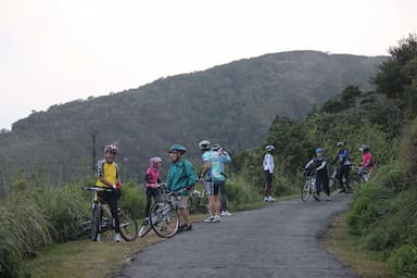 A group of cyclists watching beautiful scenes while cycling to Meemure in Sri Lanka