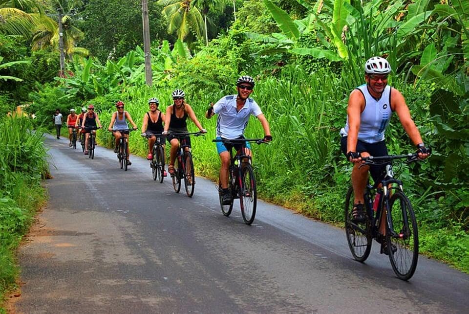 The cyclists cycling in Countryside of Tangalle in greenish area Sri Lanka