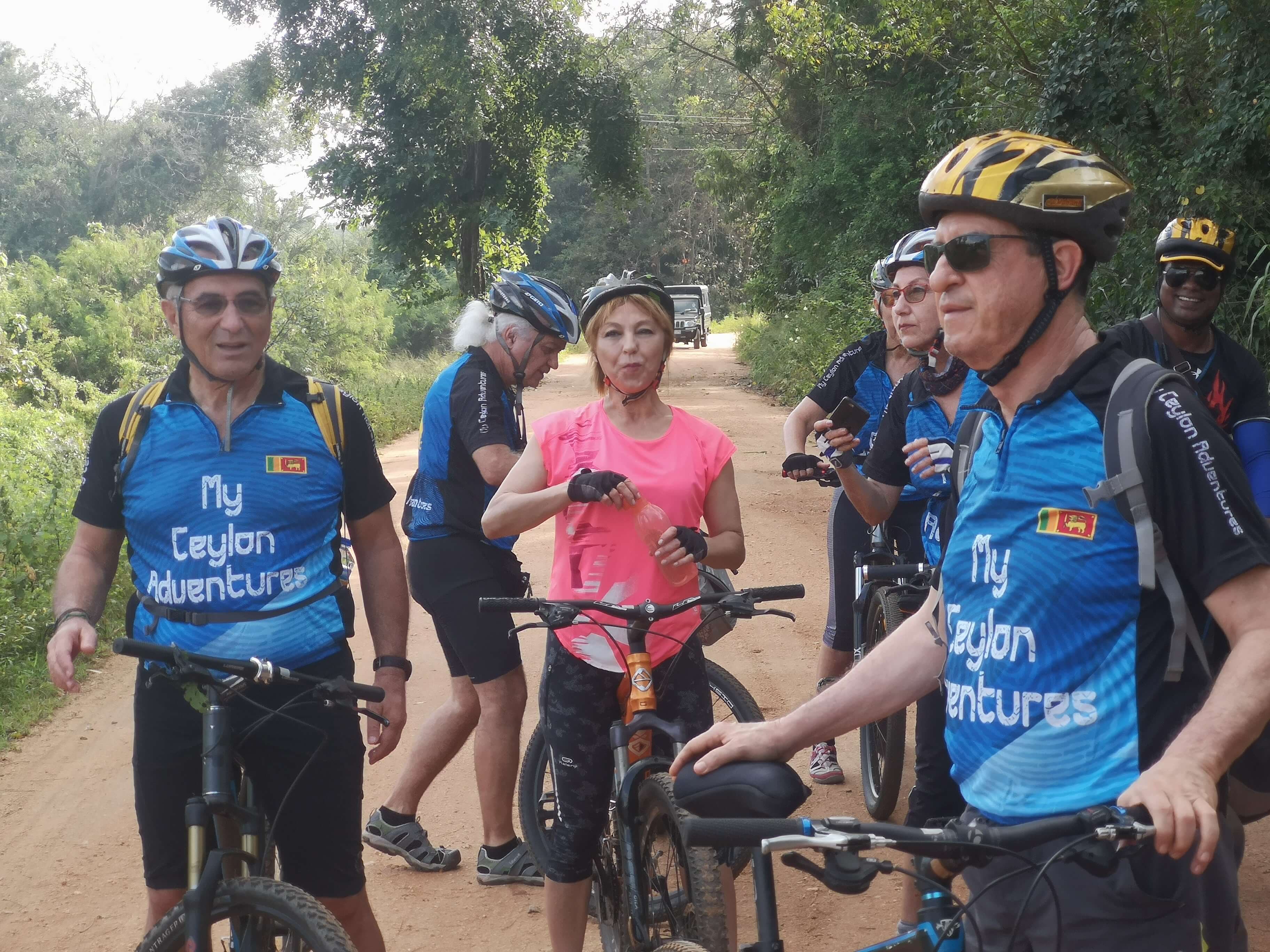 A picture of cyclists taking a short break while the cycle tour on the dirt roads