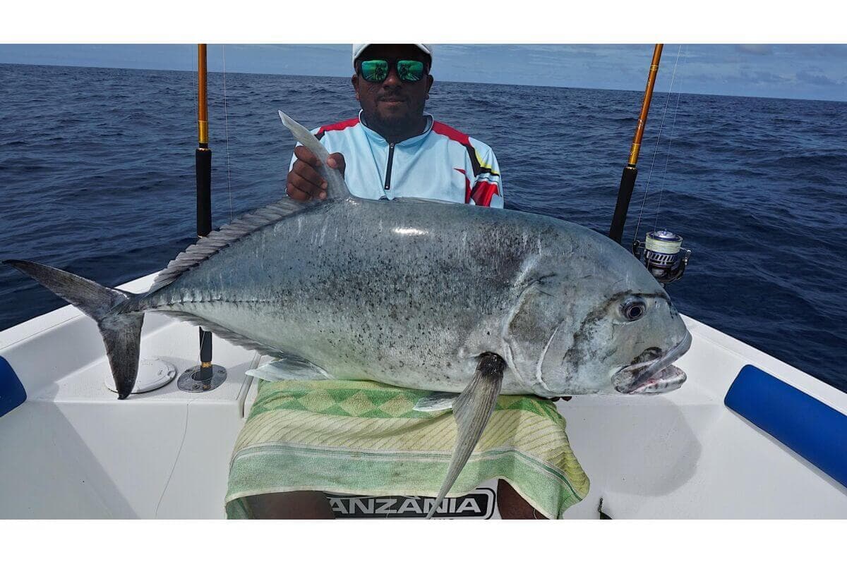 A tourist catch a giant trevally while fishing tour