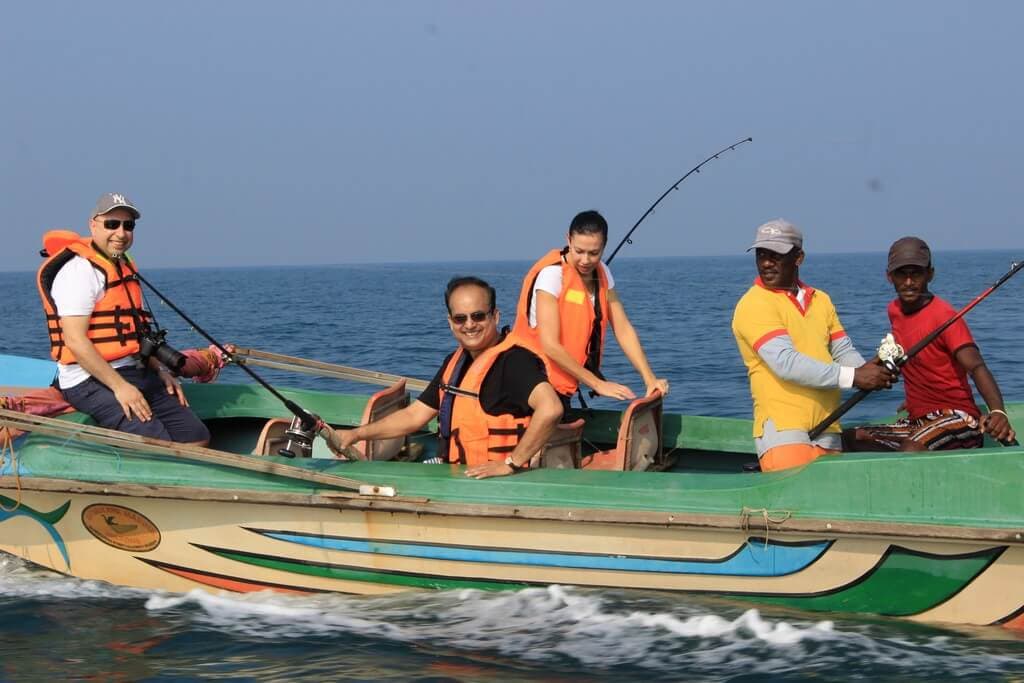 Tourists starting their fishing tour with local fishing boat in Mirissa sea Sri Lanka