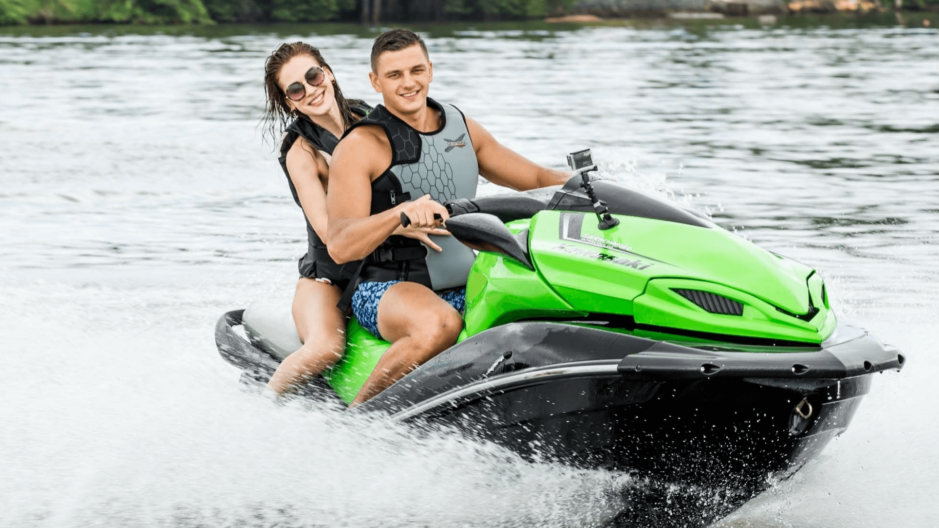 A couple enjoining with the fast Jet sky splashing water