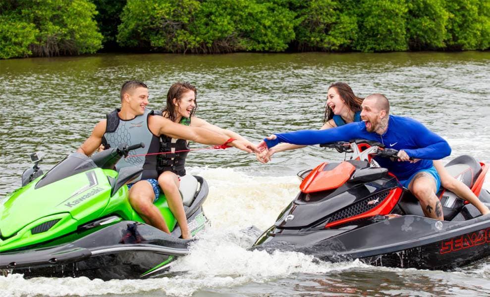 Happy two couples enjoining Jet ski ride in Bentota river Sri Lanka
