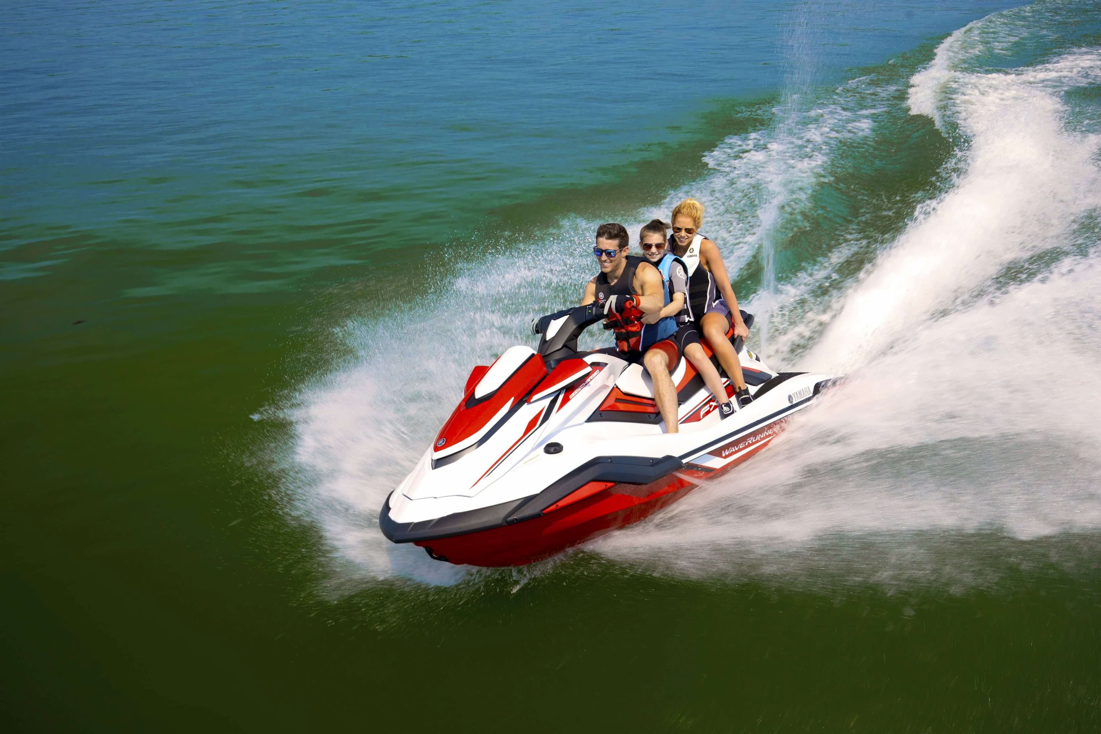 Fast family ride on Jet ski boat splashing water dramatically 