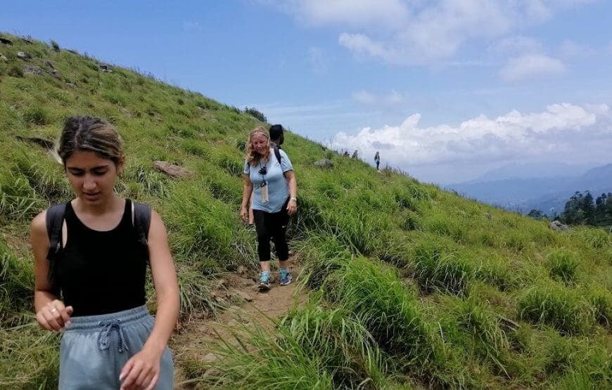 Two women trekking Hanthana mountain happily in Kandy Sri Lanka