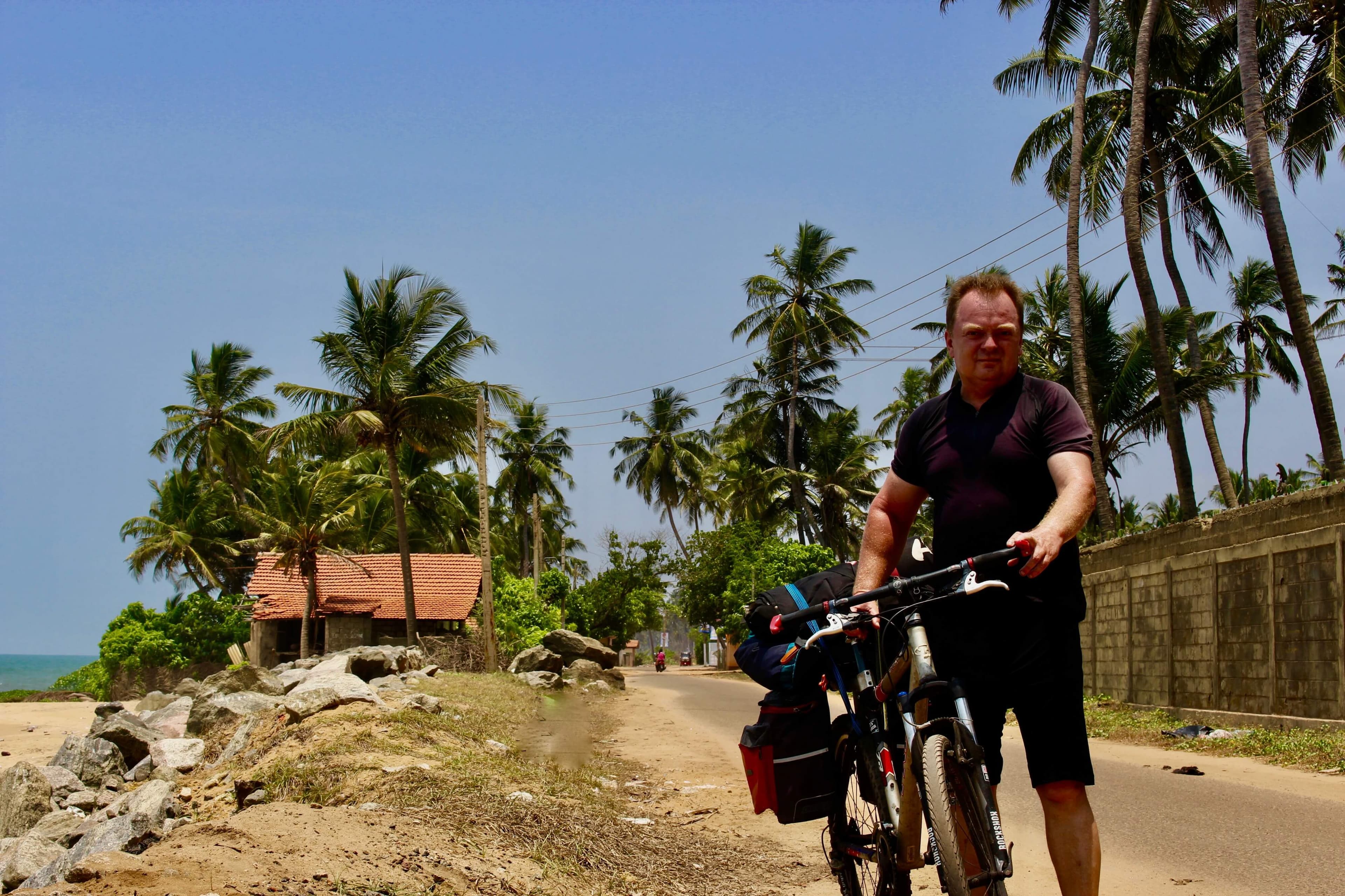 A cyclist get a photo in Negombo countryside cycling tour in Sri Lanka