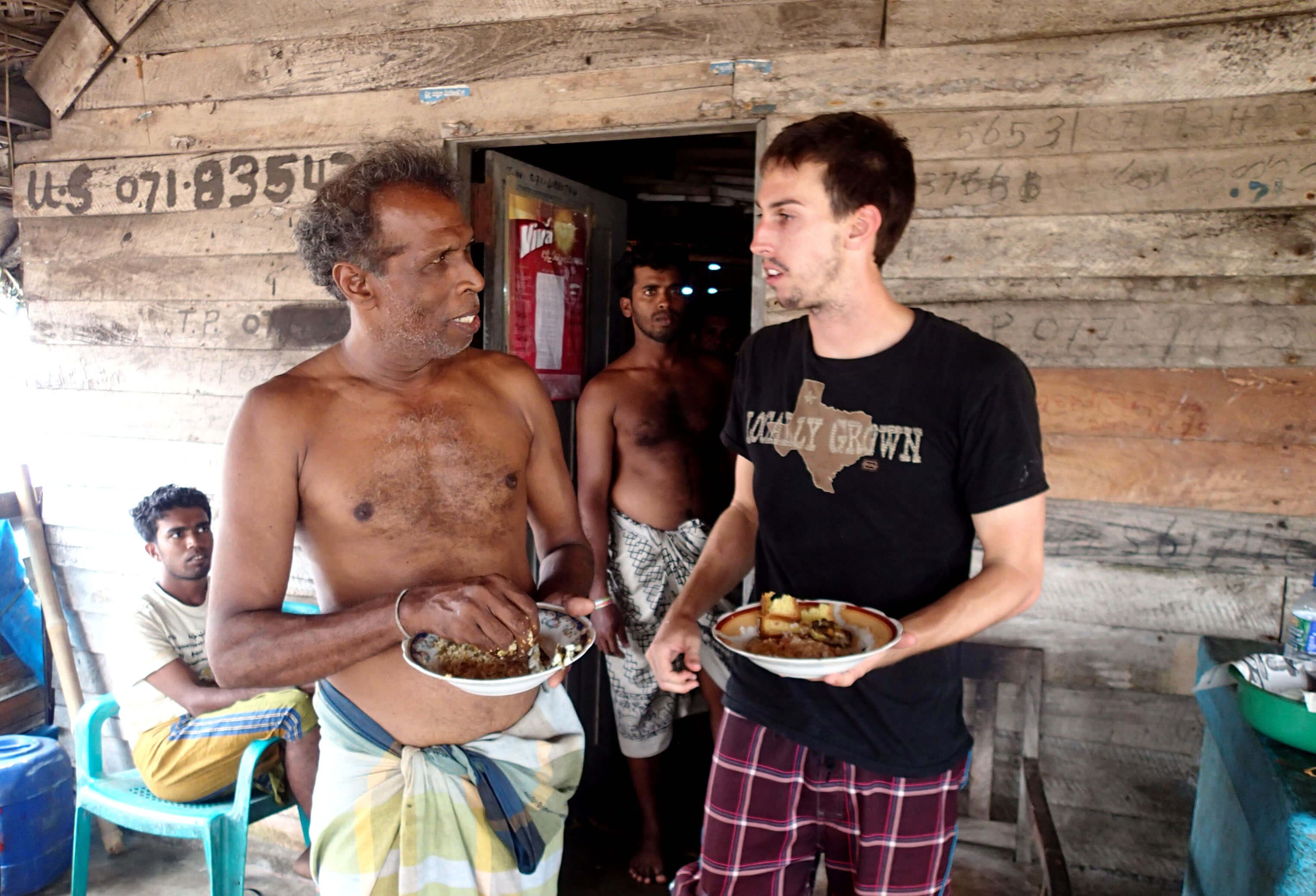 The tourists taste the local spicy lunch with fishermen in Negombo