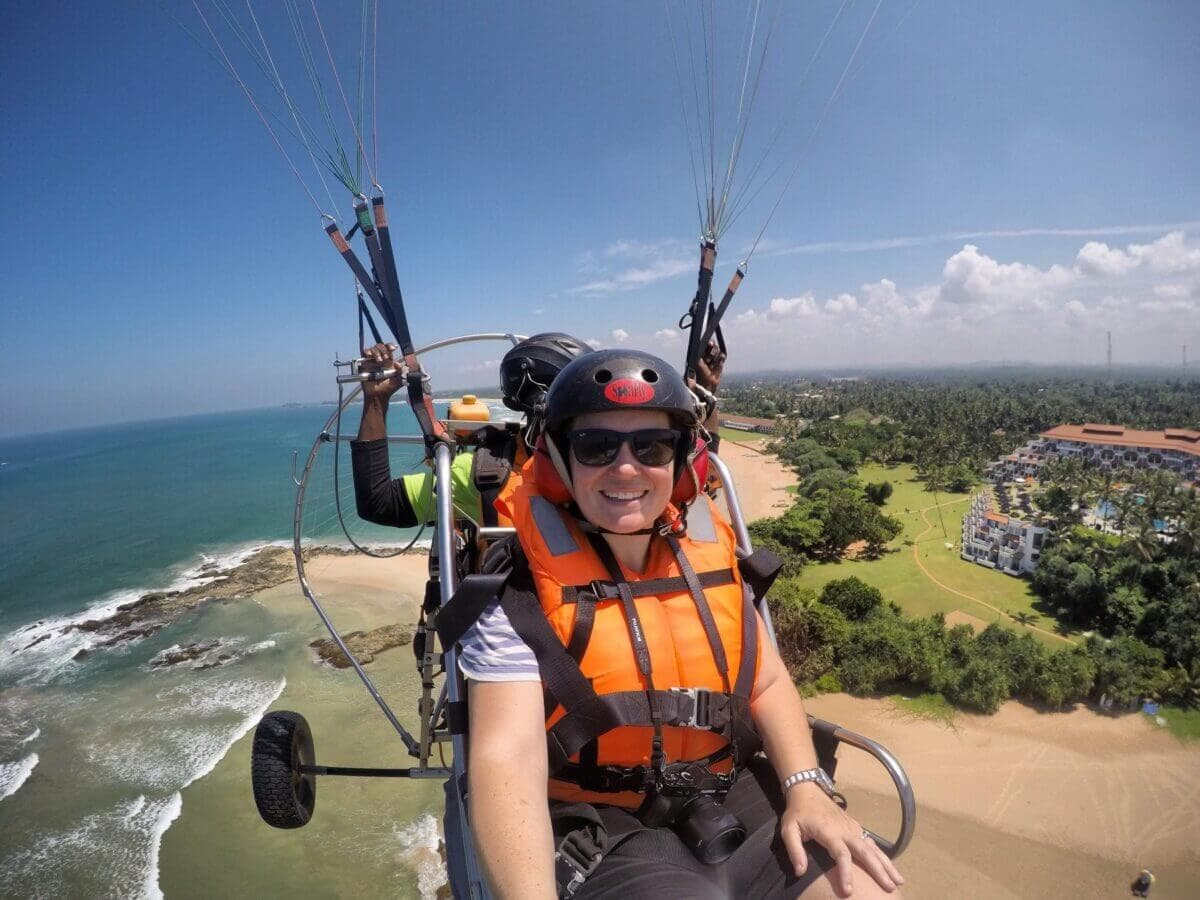 A happy tourist take a selfie while paramotoring 