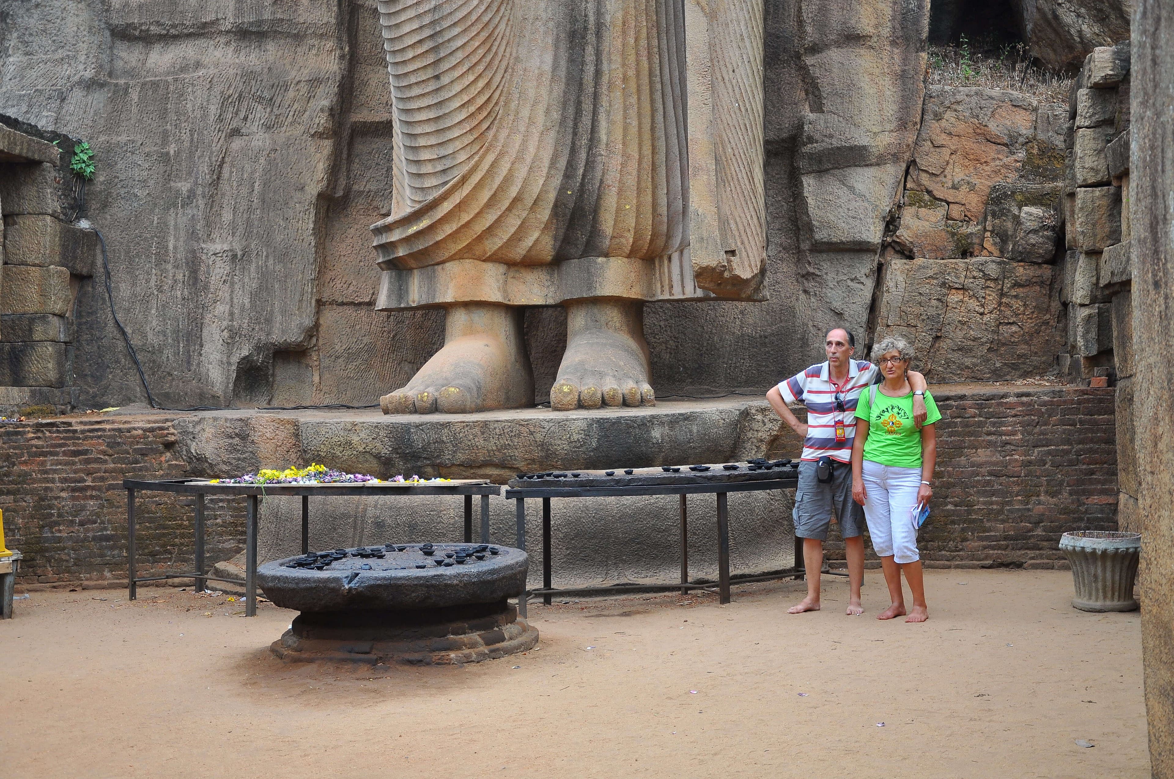 The tourist get a photograph near the tallest Avukana Buddha statue in Anuradhapura in Sri Lanka