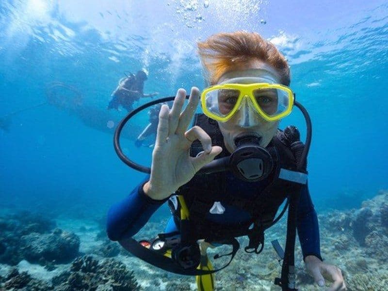 A funny movement of a diver in underwater sea