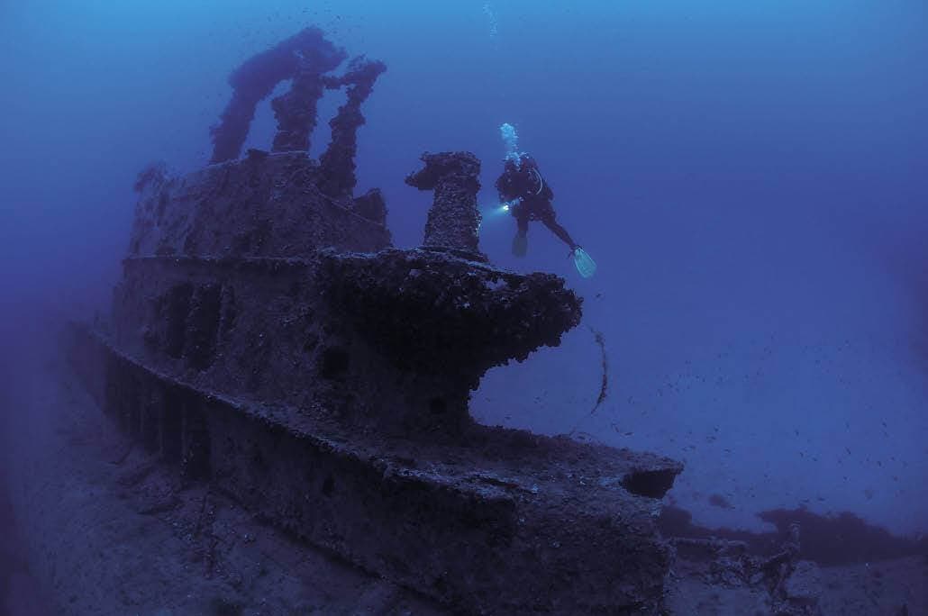 A photo of a diver explore the wreck ship in the under water sea in Sri Lanka