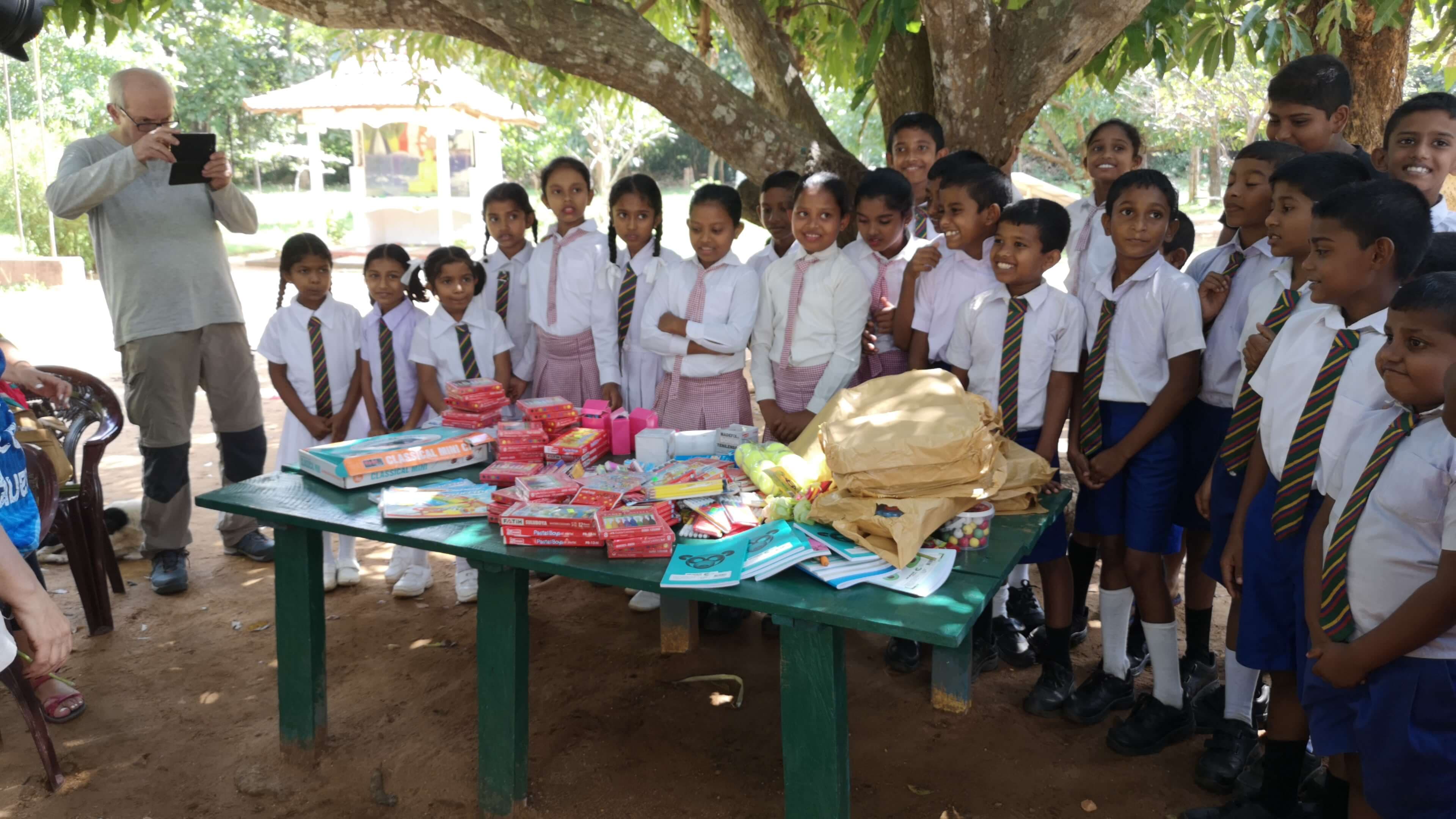 Participating in a charity giveaway organized for school kids, Sri Lanka.
