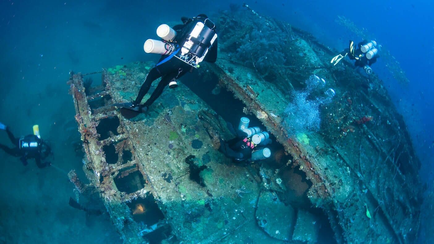 Divers near the shipwreck of a cargo ship that sank in 1994 in Colombo, Sri Lanka.