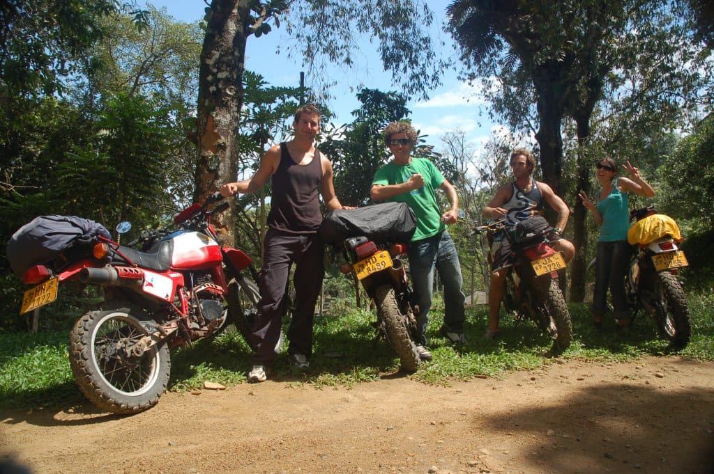 A group of bikers off road riding in the countryside, Sri Lanka.